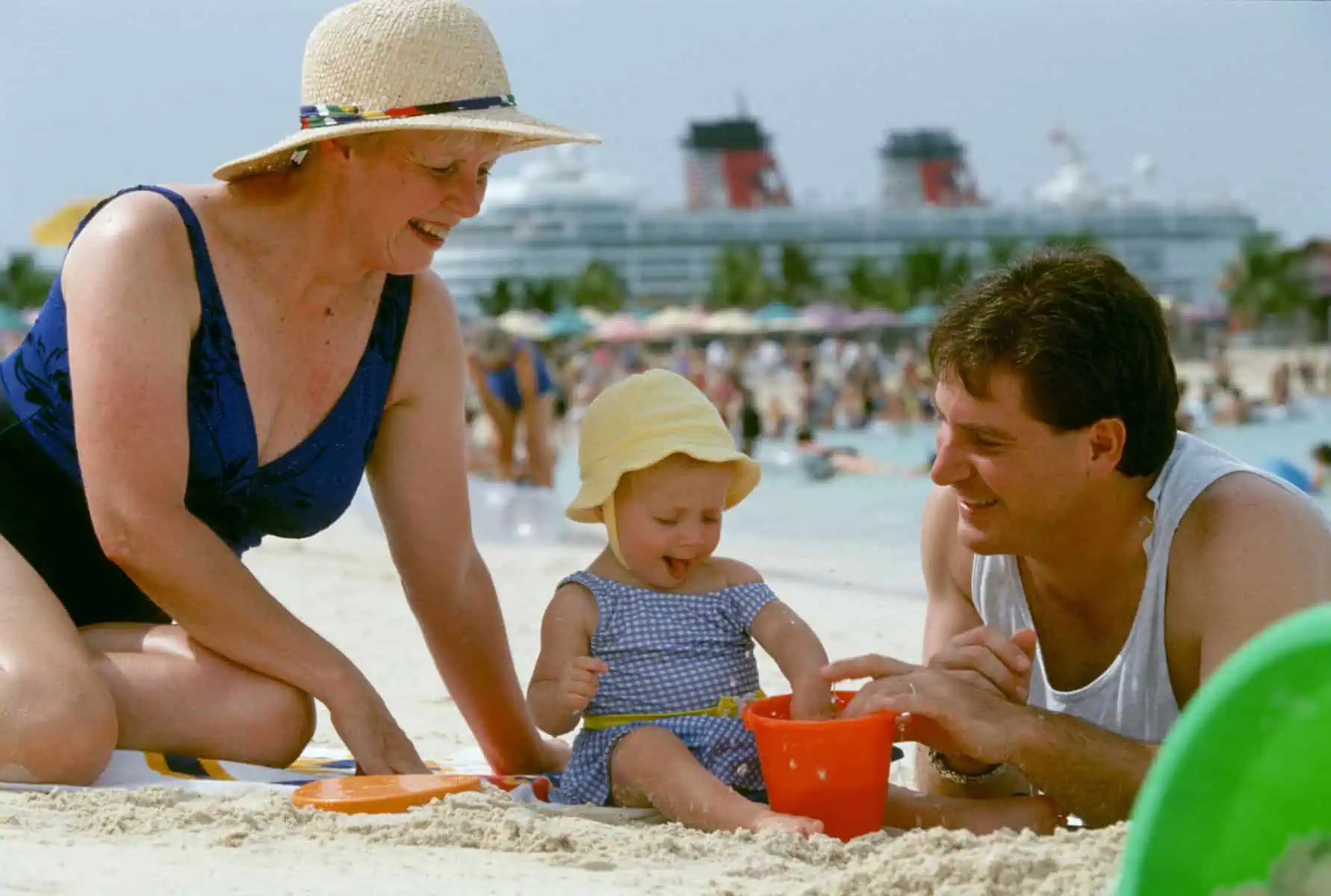Illustration for Disney Destination Planning — a dad and grandmother playing and smiling on the beach with a Disney Cruise Ship in the background.