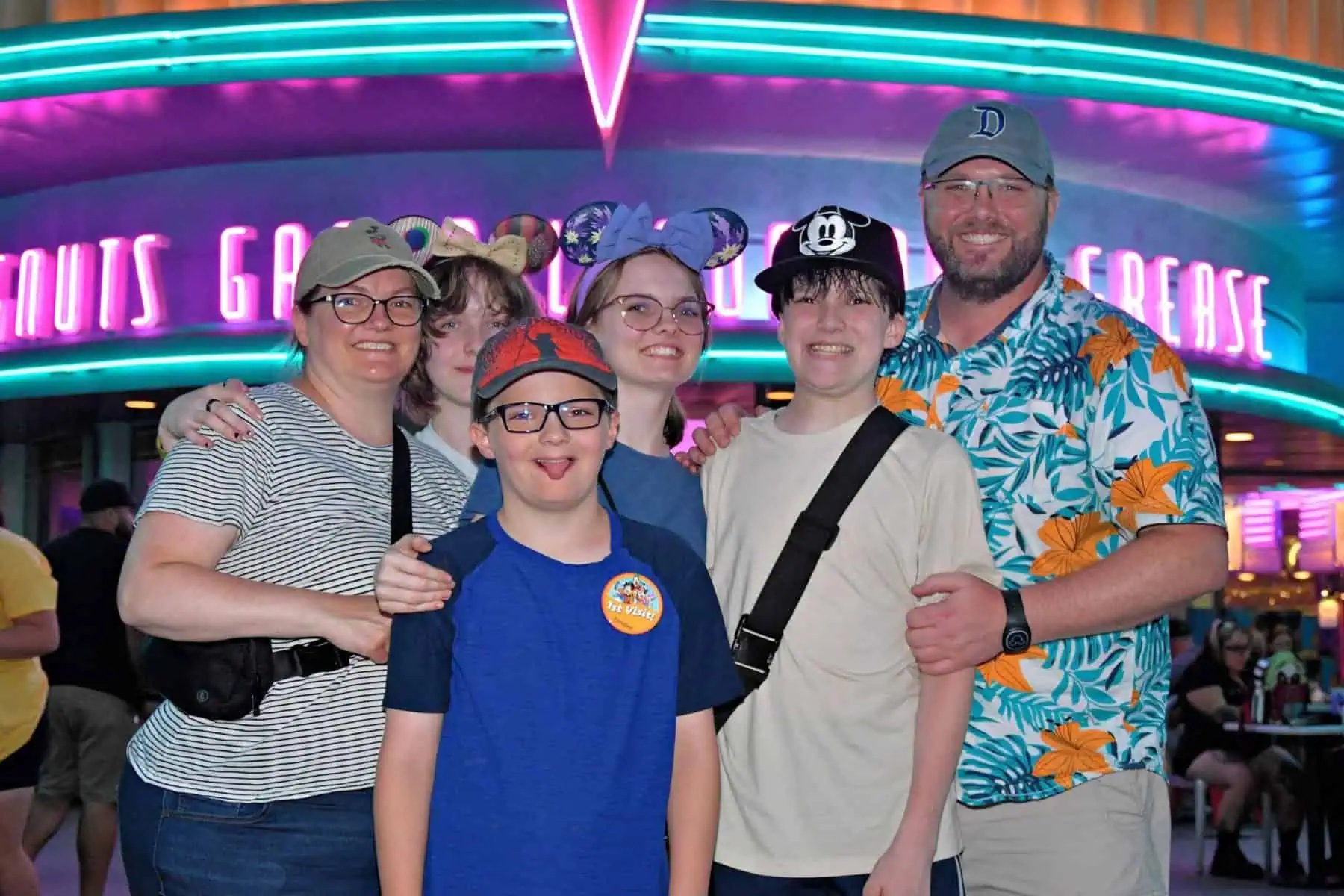 Photo of Nathan and his family in Cars Land at Disney California Adventure — a happy client family with teens who shared a testimonial about their trip.