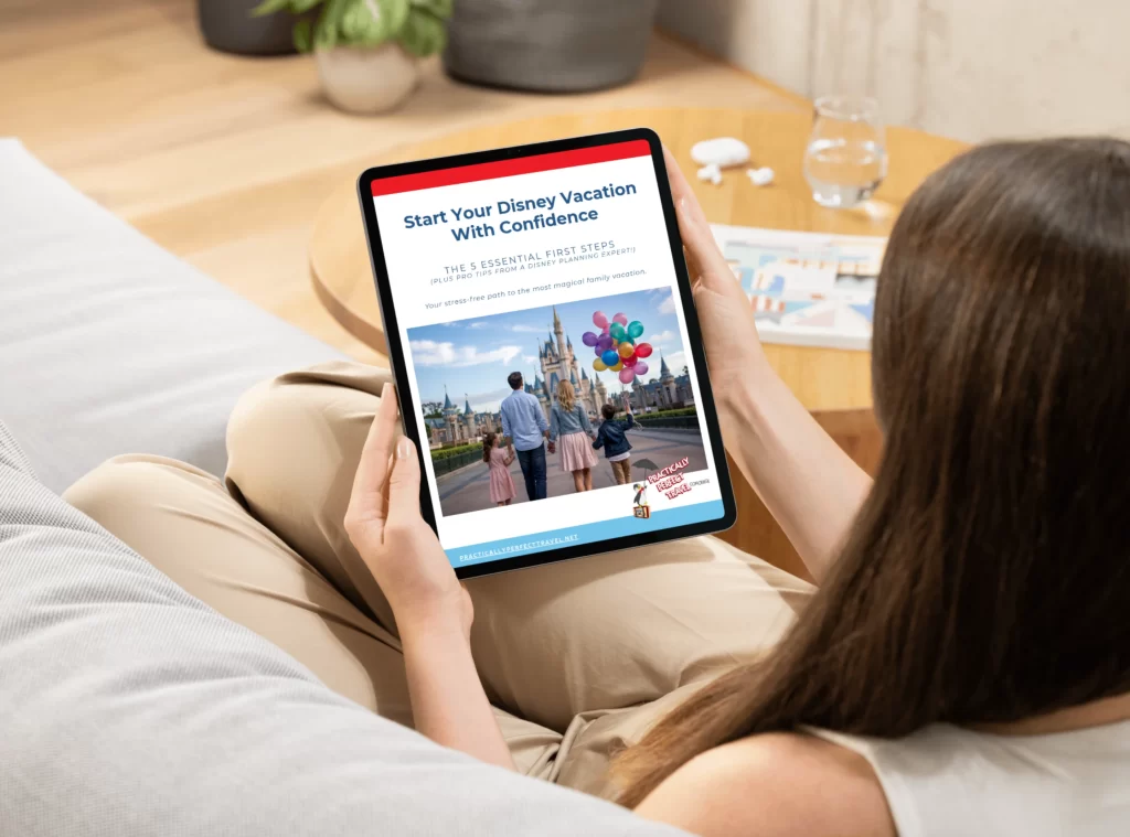 A woman relaxing on a grey couch in a bright room, holding a tablet that displays the ‘Start Your Disney Vacation With Confidence’ guide. The scene is calm and cozy, showing the ease of starting Disney trip planning from home.