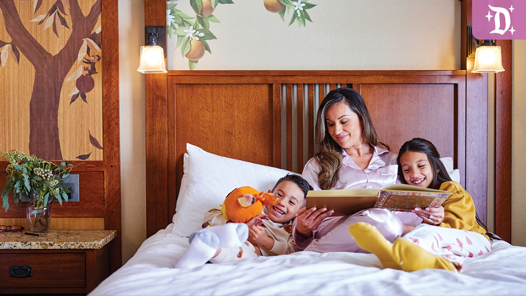 Mother and 2 daughters reading stories in a Grand Californian Resort Hotel Room Bed
