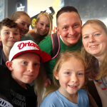 A family poses for a photo together.