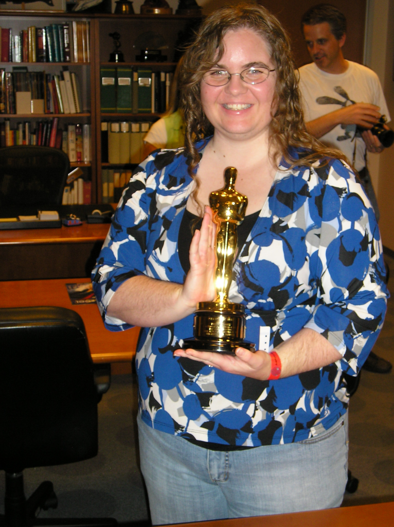 Allison Jensen holding one of Walt Disney's 22 oscars